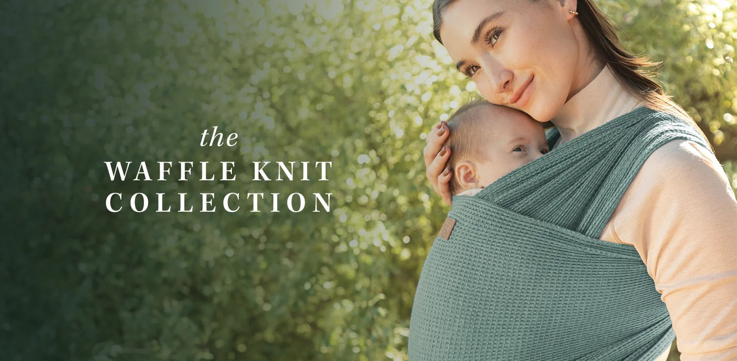 the waffle knit collection. mom wearing baby in waffle knit wrap in saguaro