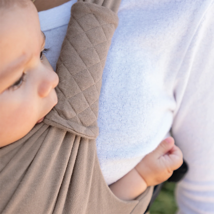 closeup image of mom wearing baby in moby duet carrier in sparrow