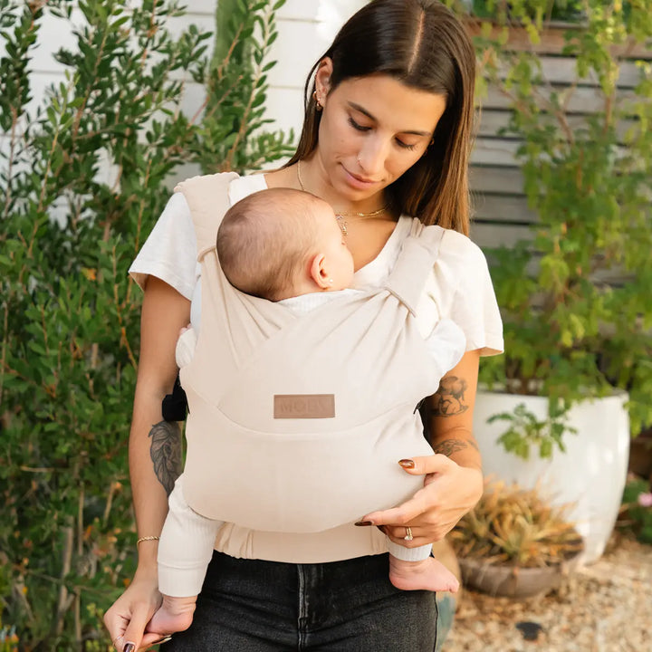 mom wearing baby in moby duet carrier in feather