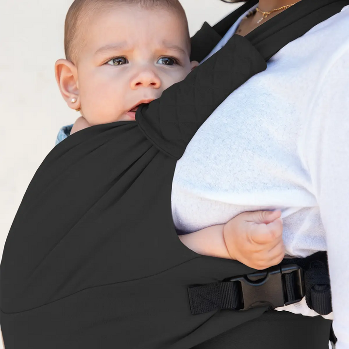 closeup image of mom wearing baby in moby duet carrier in dusk