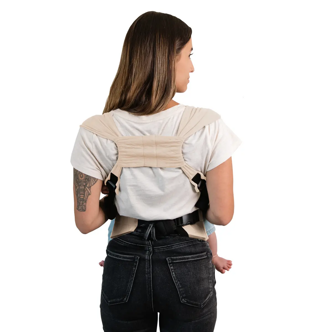 back image of mom wearing baby in duet carrier in feather