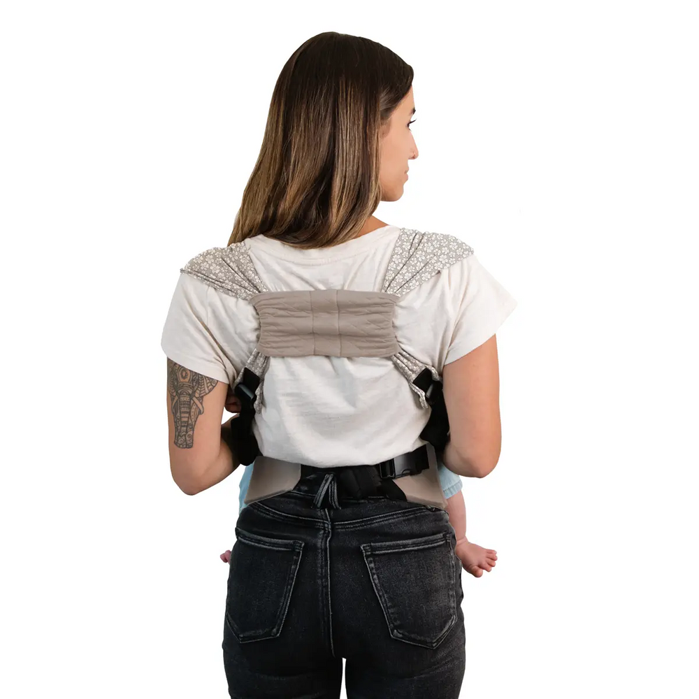 back image of mom wearing baby in dueyt carrier in prairie blooms