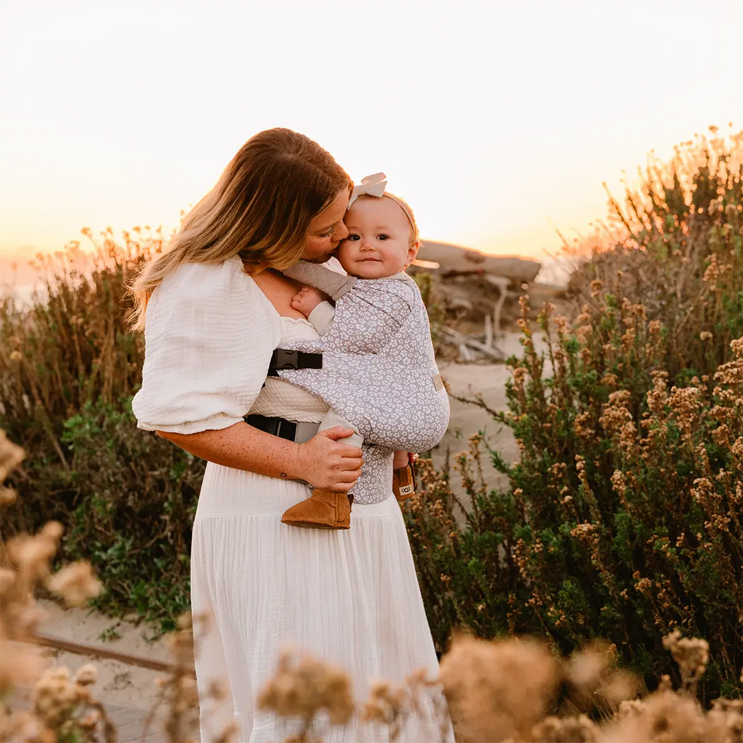 mom wearing baby in deut carrier in prairie blooms