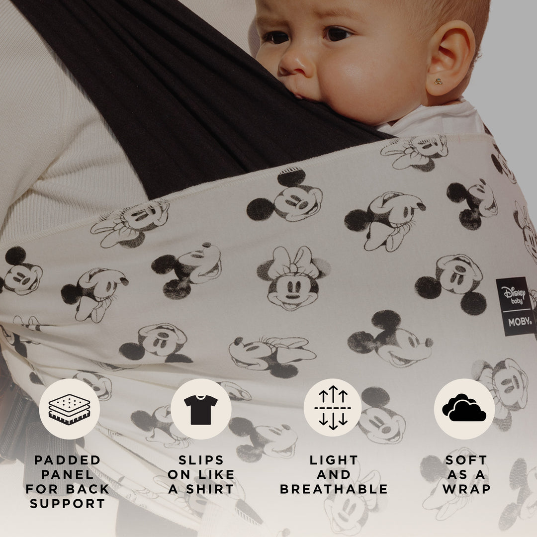 mom wearing baby in Easy-Wrap Carrier in Disney's Mickey Mouse & Minnie Mouse. padded panel for back support, slips on like a shirt, light and breathable, soft as a wrap