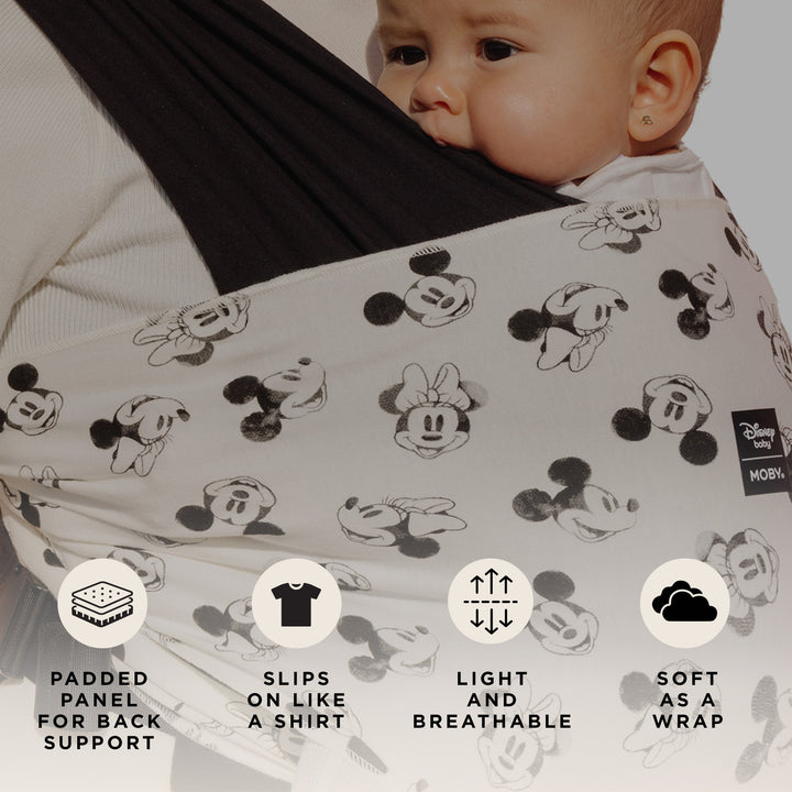 mom wearing baby in Easy-Wrap Carrier in Disney's Mickey Mouse & Minnie Mouse. padded panel for back support, slips on like a shirt, light and breathable, soft as a wrap