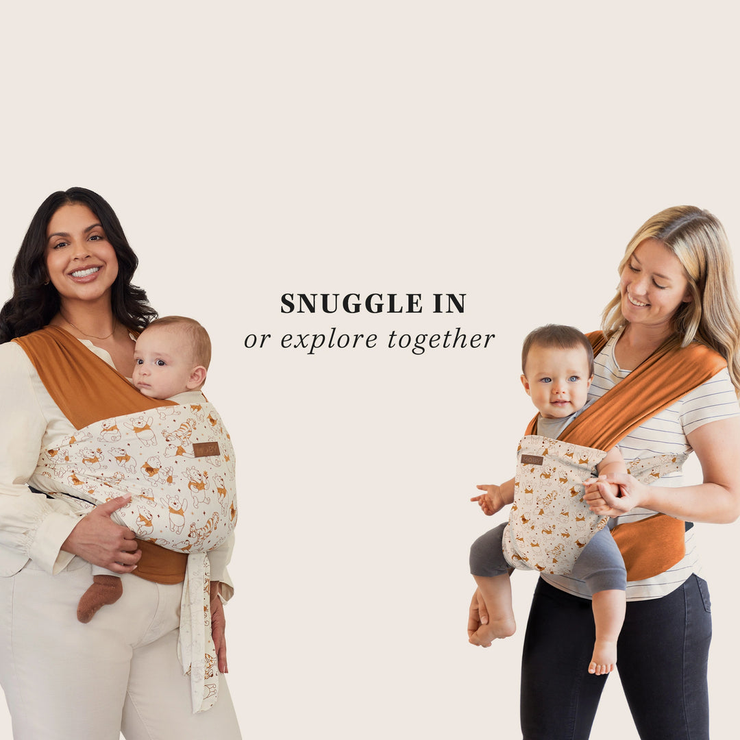 two moms pictured wearing babies of different ages in easy-wrap winnie the pooh. snuggle in or explore together.