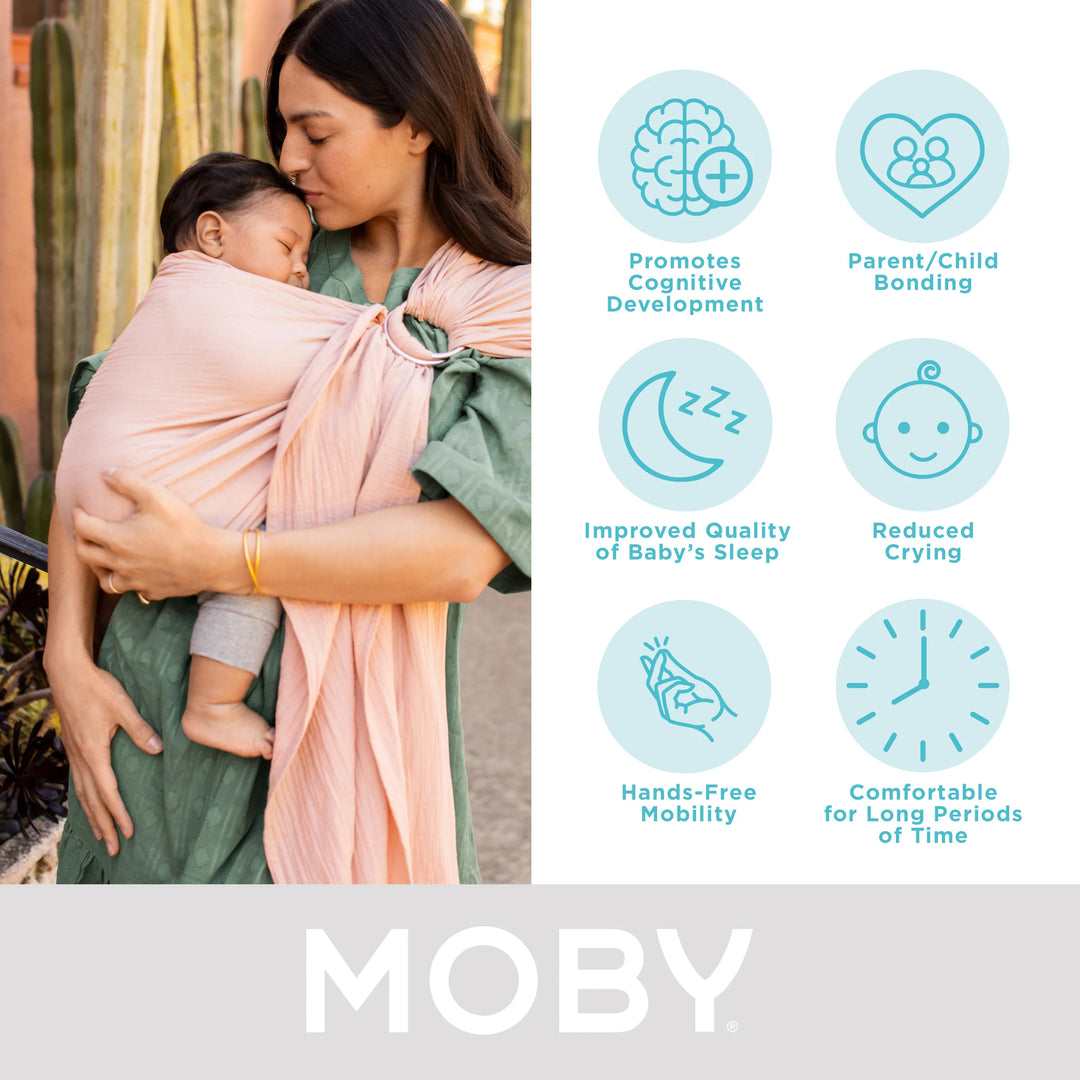 mom wearing baby in moby ring sling. promotes cognitive development, parent/child bonding, improved quality of baby's sleep, reduced crying, hands-free mobility, comfortable for long periods of time.