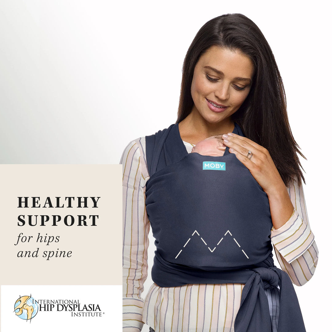 Mom wearing baby in Classic Wrap Baby Carrier in Deep Sea. healthy support for hips and spine. international hip dysplasia institute