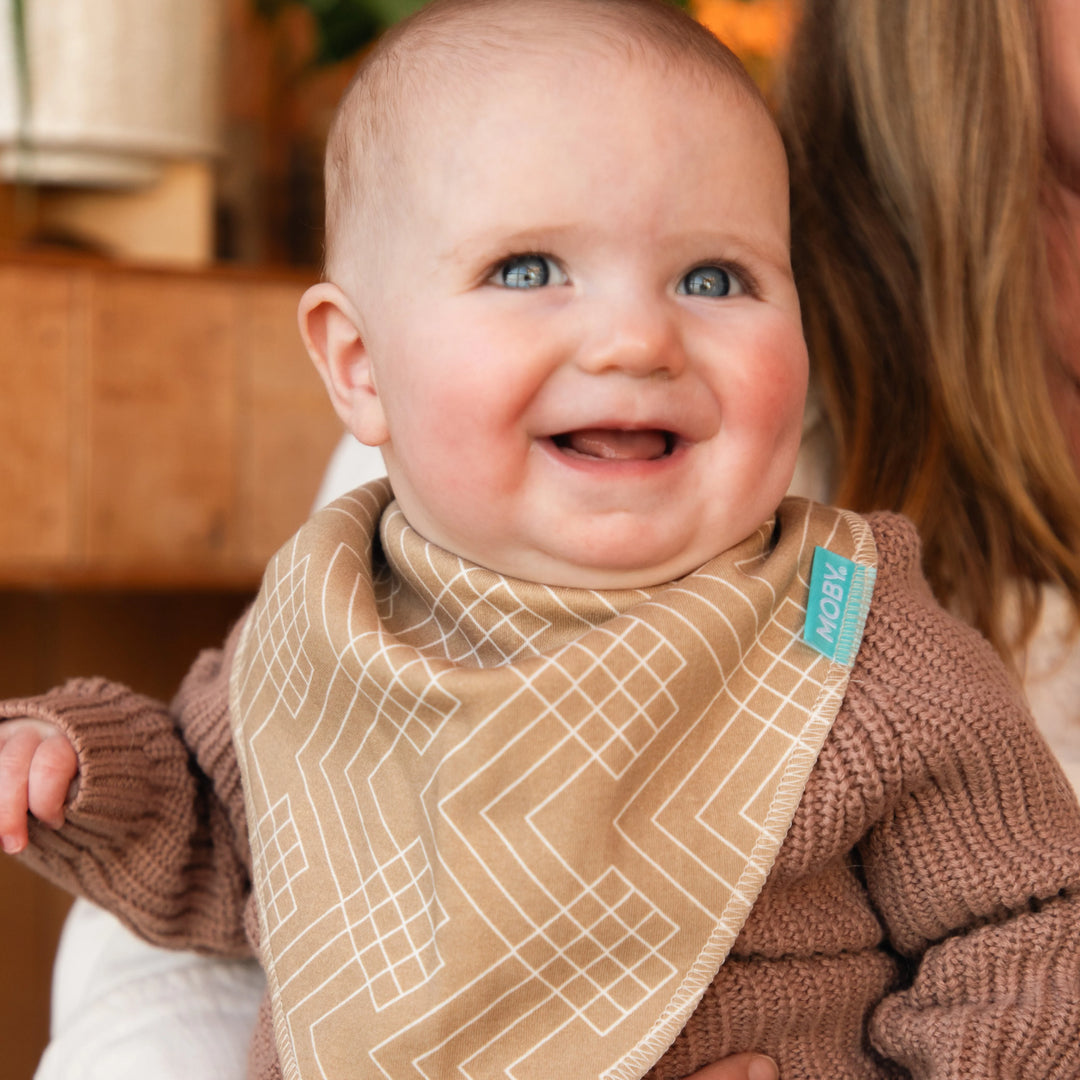 baby wearing reversible bib set in pattern sand waves