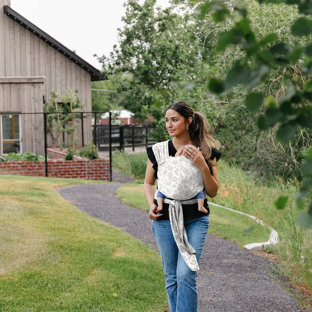 mom wearing baby in classic wrap in bandana