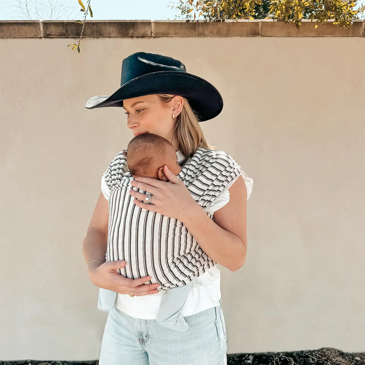 mom wearing baby in Classic Wrap Baby Carrier in Heirloom Stripe