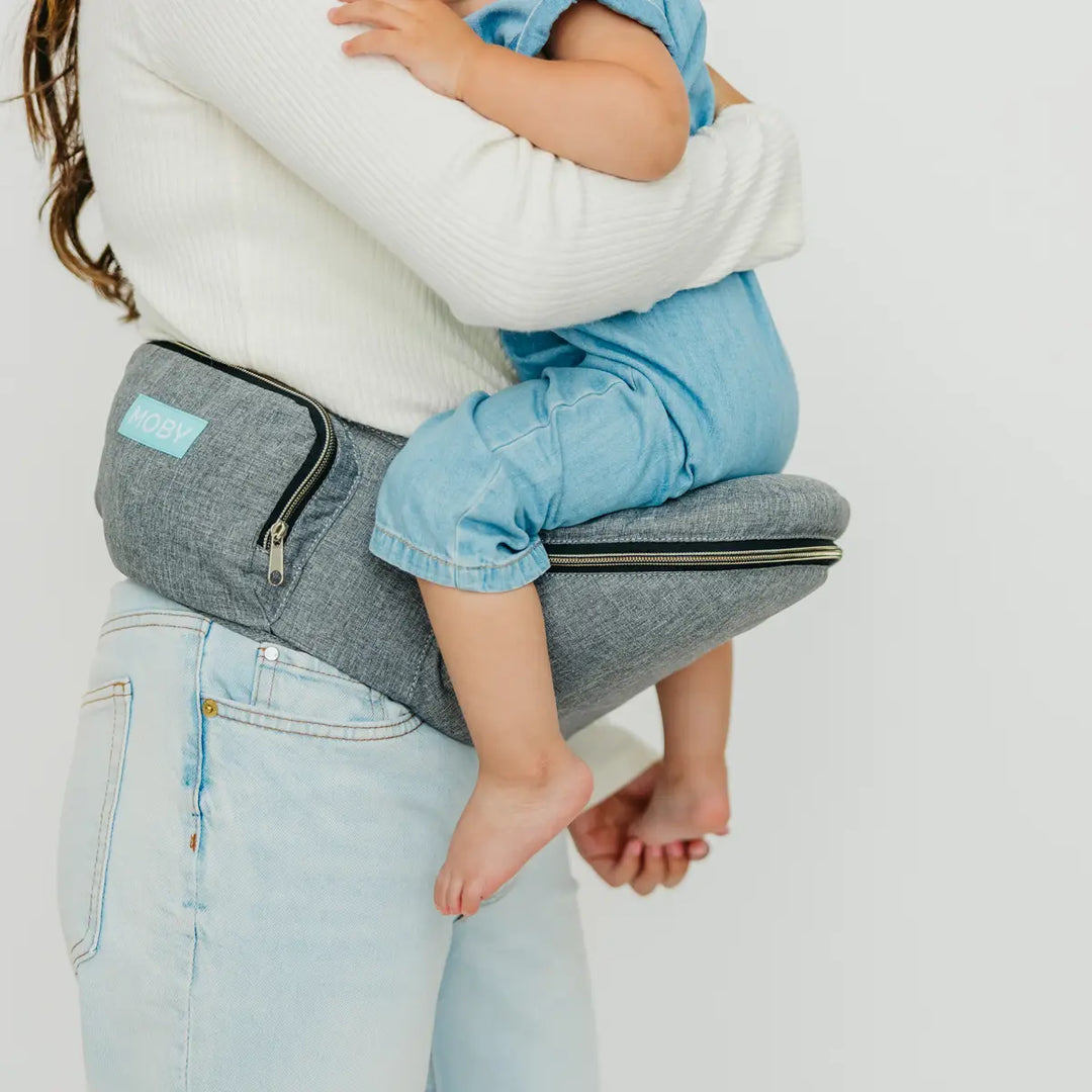 mom wearing baby in hip seat in heather grey