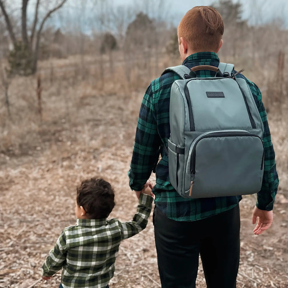 dad wearing Parent Pack Diaper Bag in Pine