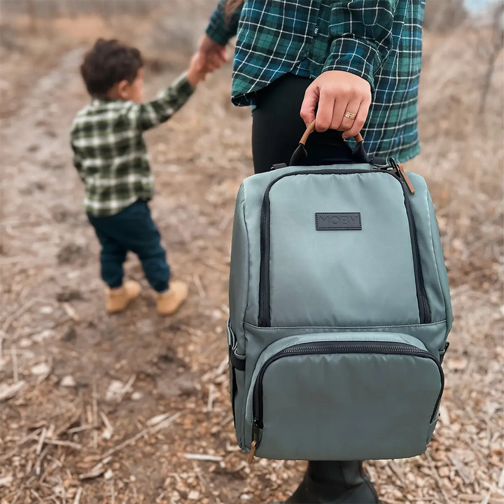 dad holding Parent Pack Diaper Bag in Pine