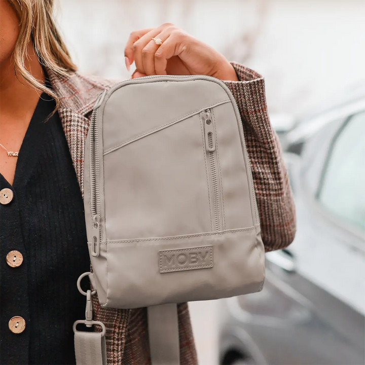 mom holding the Transit Cross Body in Dune