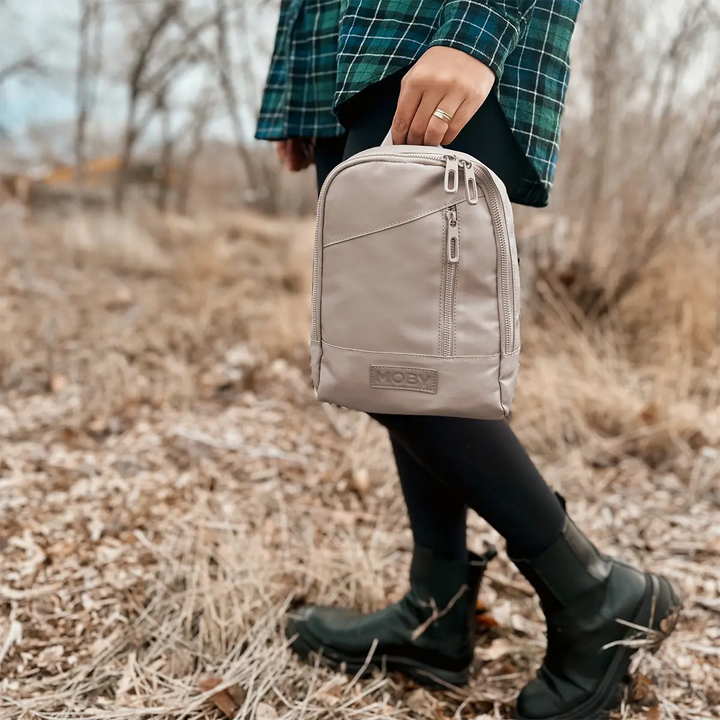 mom holding the Transit Cross Body in Dune