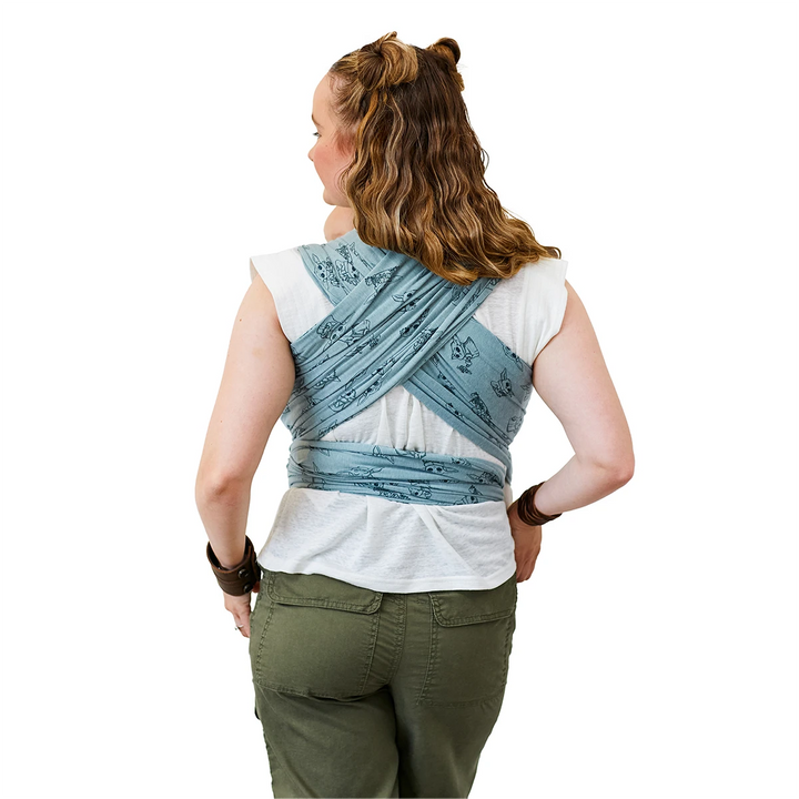 back image of Mom wearing baby in Moby Featherknit Wrap in Playful Padawan