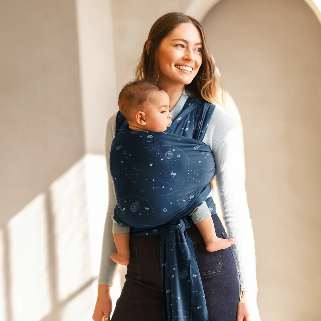 mom wearing baby in Featherknit Wrap in Hyperspace Traffic