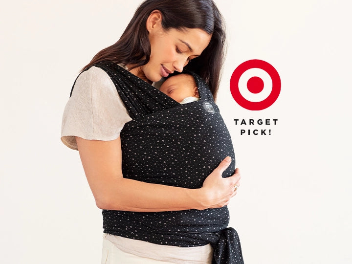 target pick! mom wearing baby in the classic wrap carrier by petunia pickle bottom in terrazzo