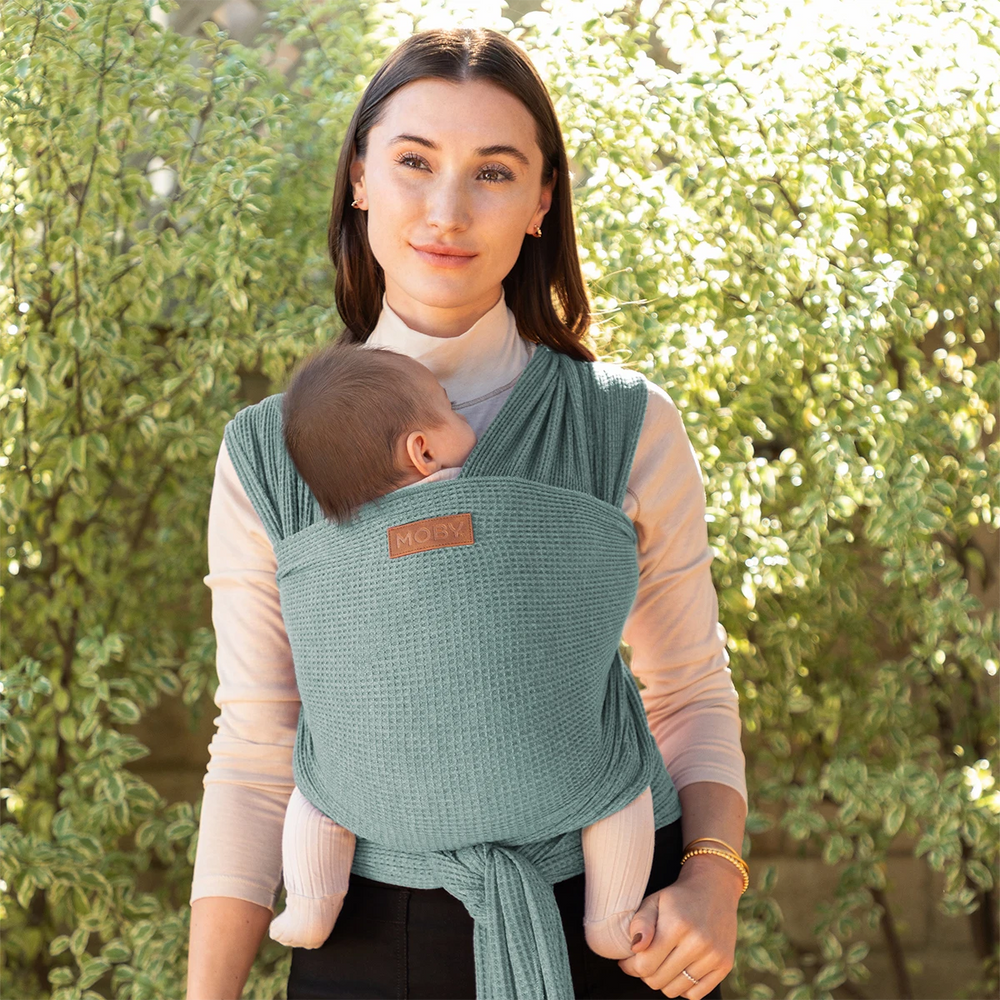 mom wearing baby in waffle knit wrap in saguaro