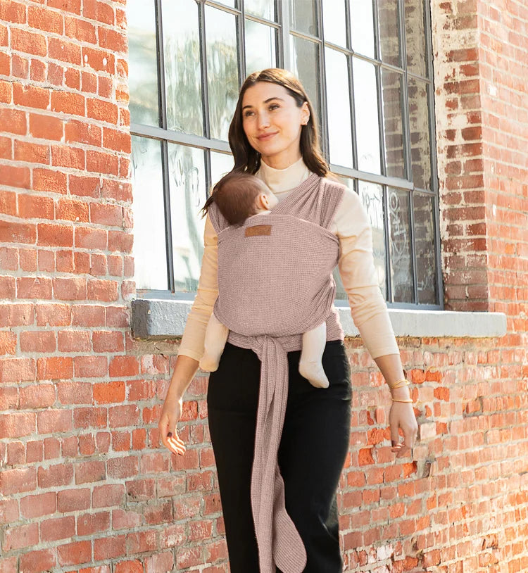 mom wearing baby in moby's waffle knit wrap. 