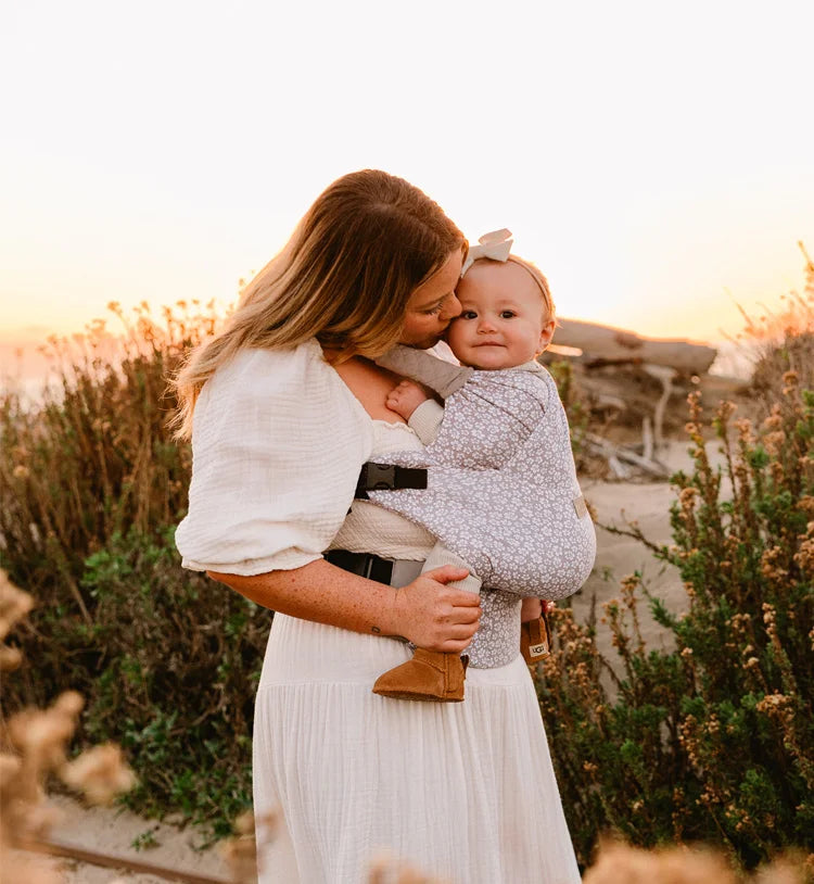 mom wearing baby in duet carrier in prairie blooms