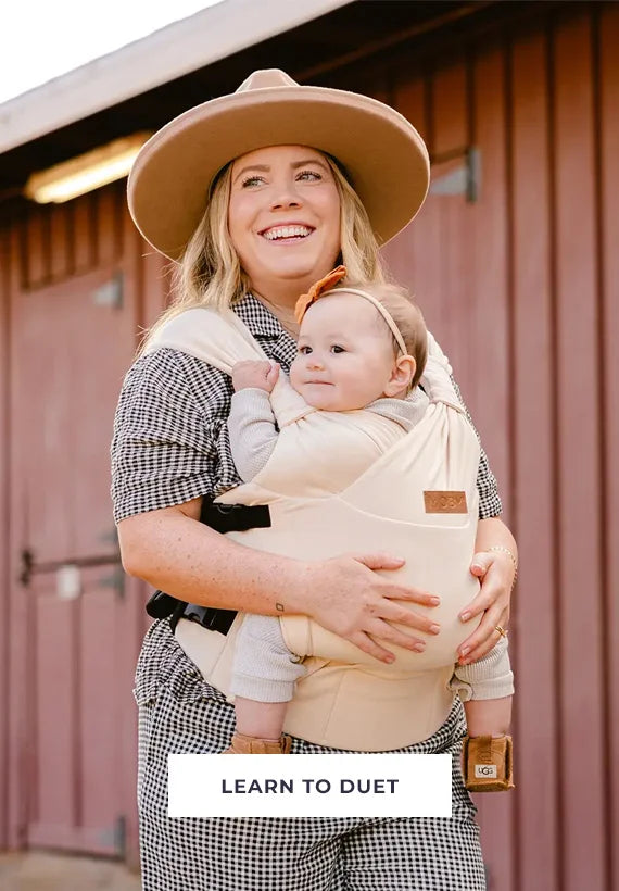 mom carrying baby in duet carrier in feather