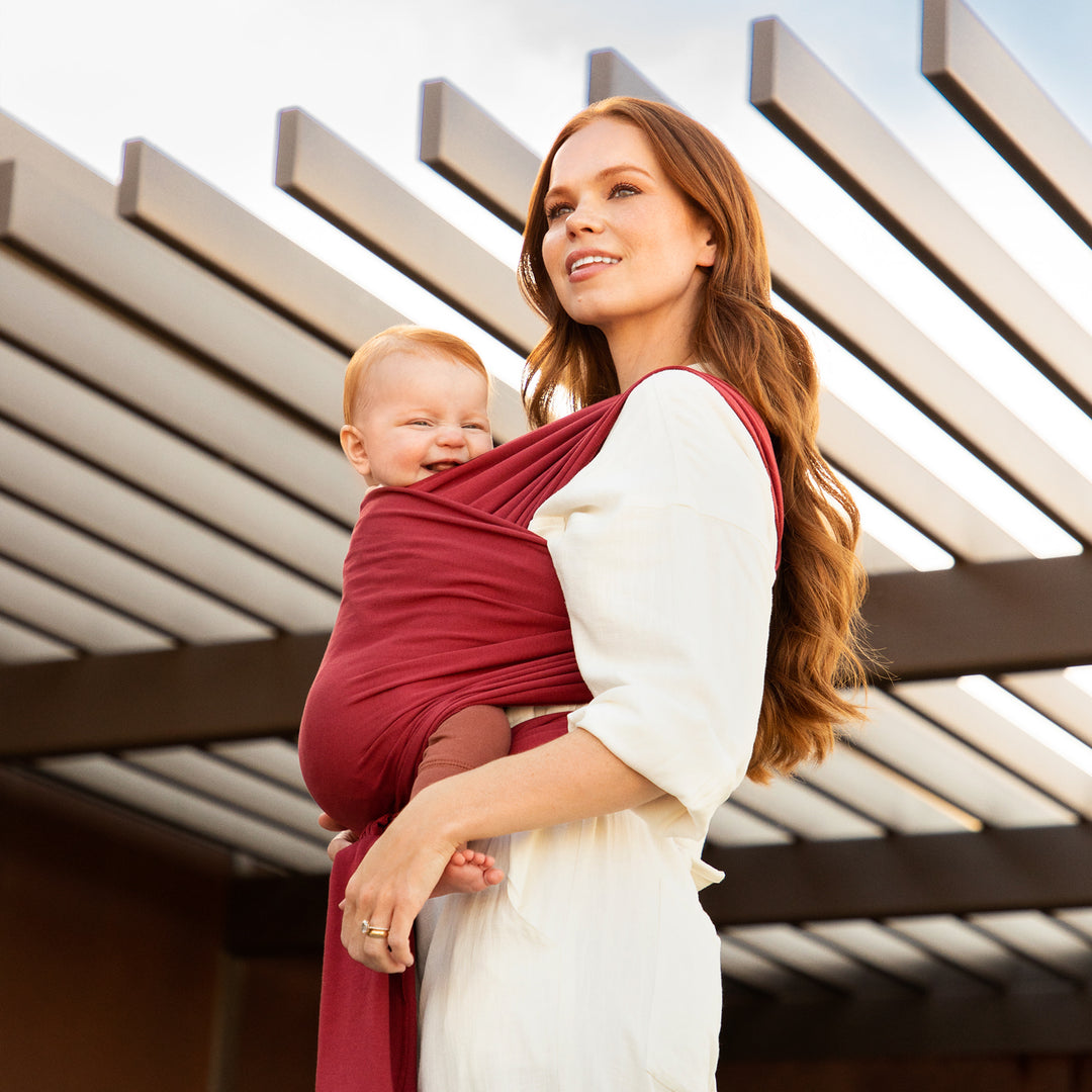 mom wearing baby in the moby classic wrap in ruby